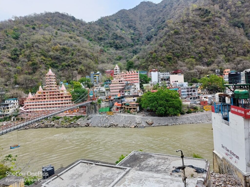 Iconic temple on the Ganga riverbank in Rishikesh with mountains in the background
