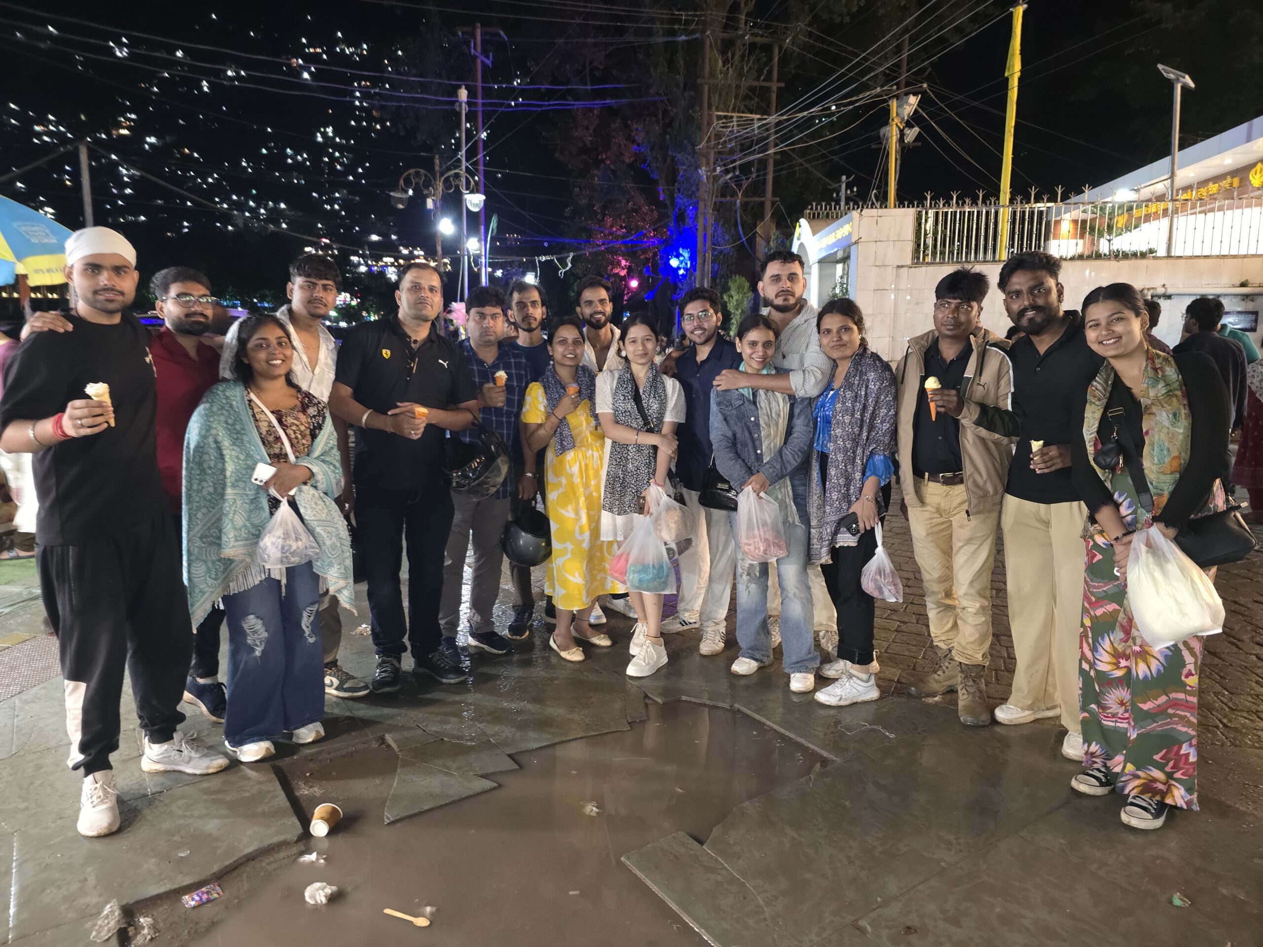 Tourists taking photos at night near Naini Lake in Nainital
