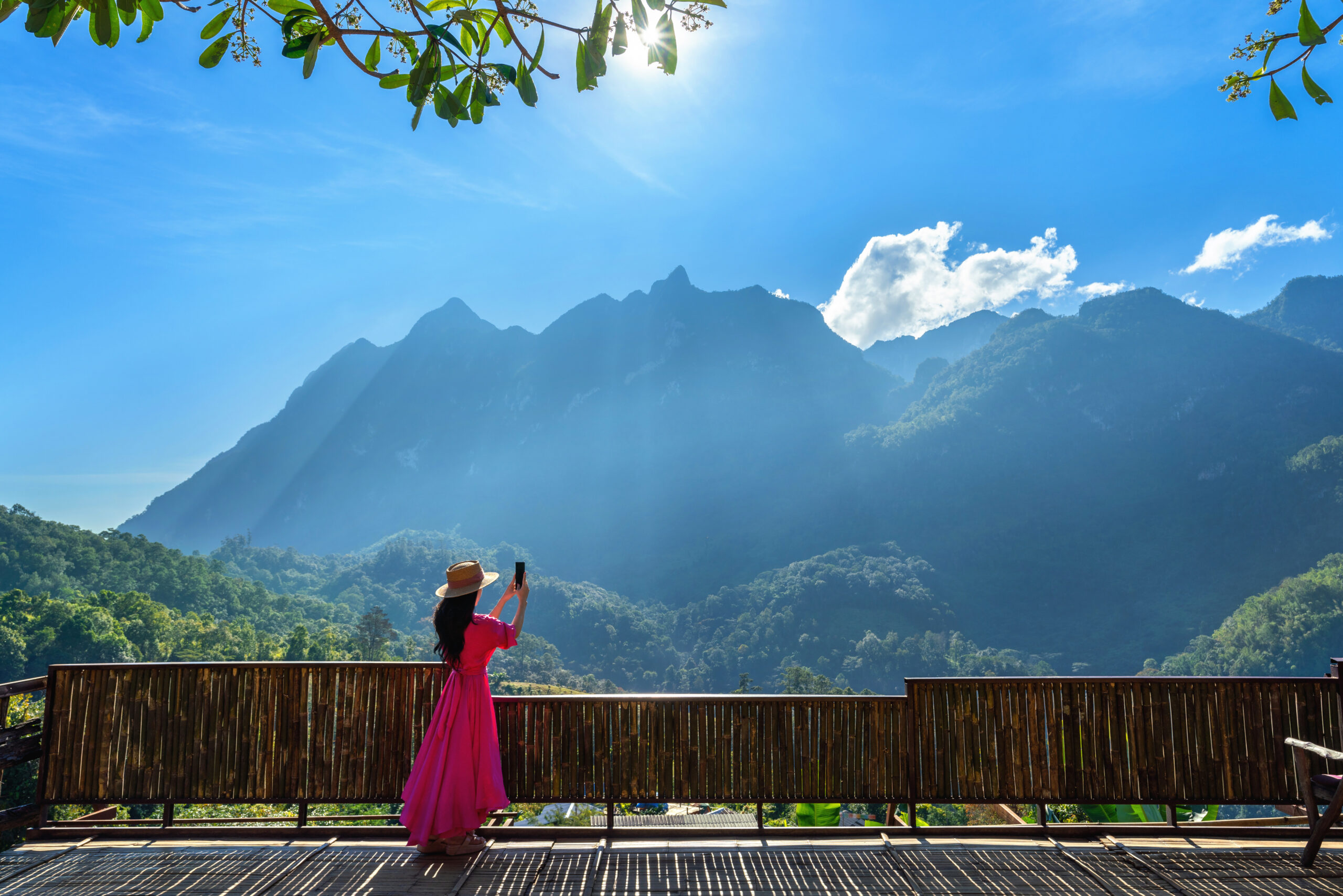 Girl capturing mountain view with camera in Uttarakhand